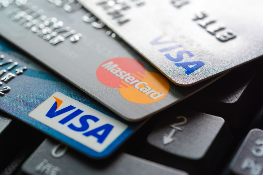 43482502 - group of credit cards on computer keyboard with visa and mastercard brand logos